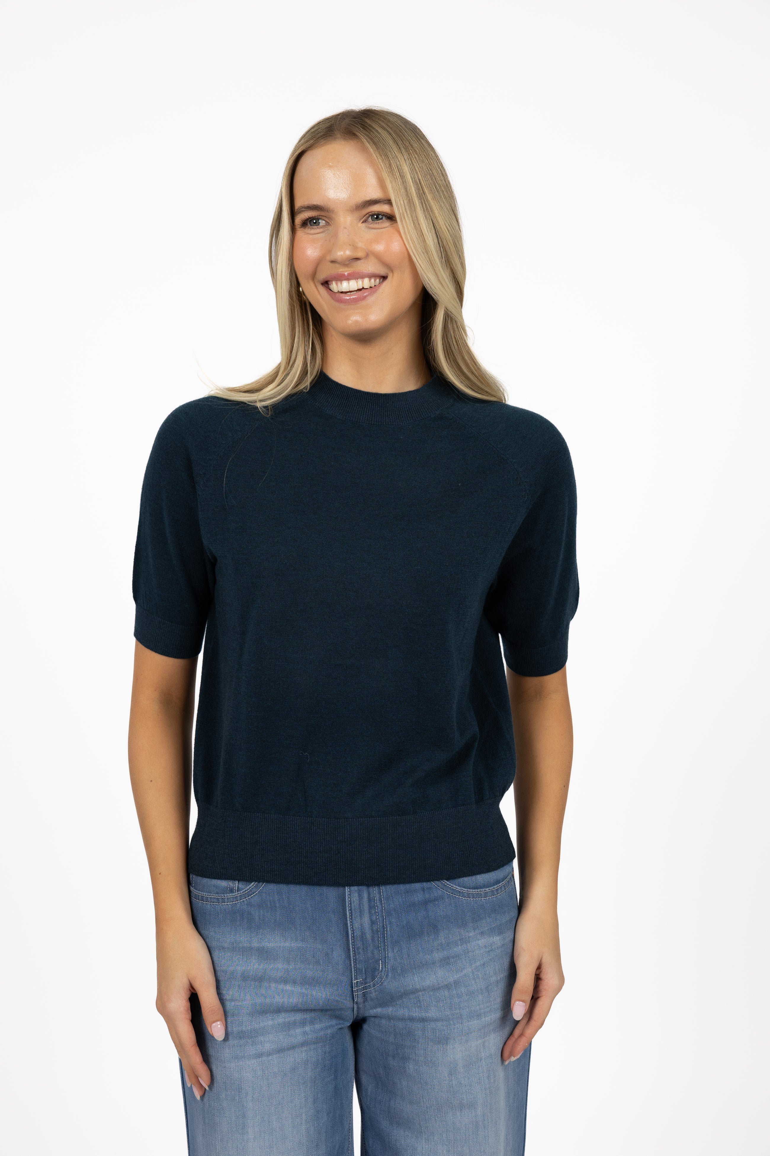Humidity Lifestyle Aurora Top in chocolate and deep sea, crafted from a lightweight knit with a soft drape, high neckline, and relaxed short sleeves. Features ribbed cuffs and hem for subtle structure, creating a versatile transeasonal style that can be worn loose or tucked, styled casually with denim, or dressed up with tailored pieces.