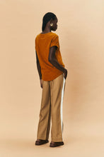 Load image into Gallery viewer, Introducing the new We are the Others, Alba Pant in a rich stone color, featuring a stylish contrast bone stripe down the side leg. Crafted from a comfy twill fabrication, these pants offer a relaxed fit and an elastic waist for ultimate comfort. Perfect for elevating your casual look or dressing up for a night out, the Alba Pant combines effortless style with everyday ease.
