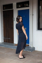 The NES Flow Dress is a multi-seasonal, versatile style that seamlessly transitions from casual to formal occasions. This dress offers a variety of styling options—wear it draped down across the front for a relaxed look, or cinch it up at the side using the adjustable side button and hem loopers for a more structured appearance. The perfect balance of comfort and elegance, this dress can be styled with our Lattice Slip