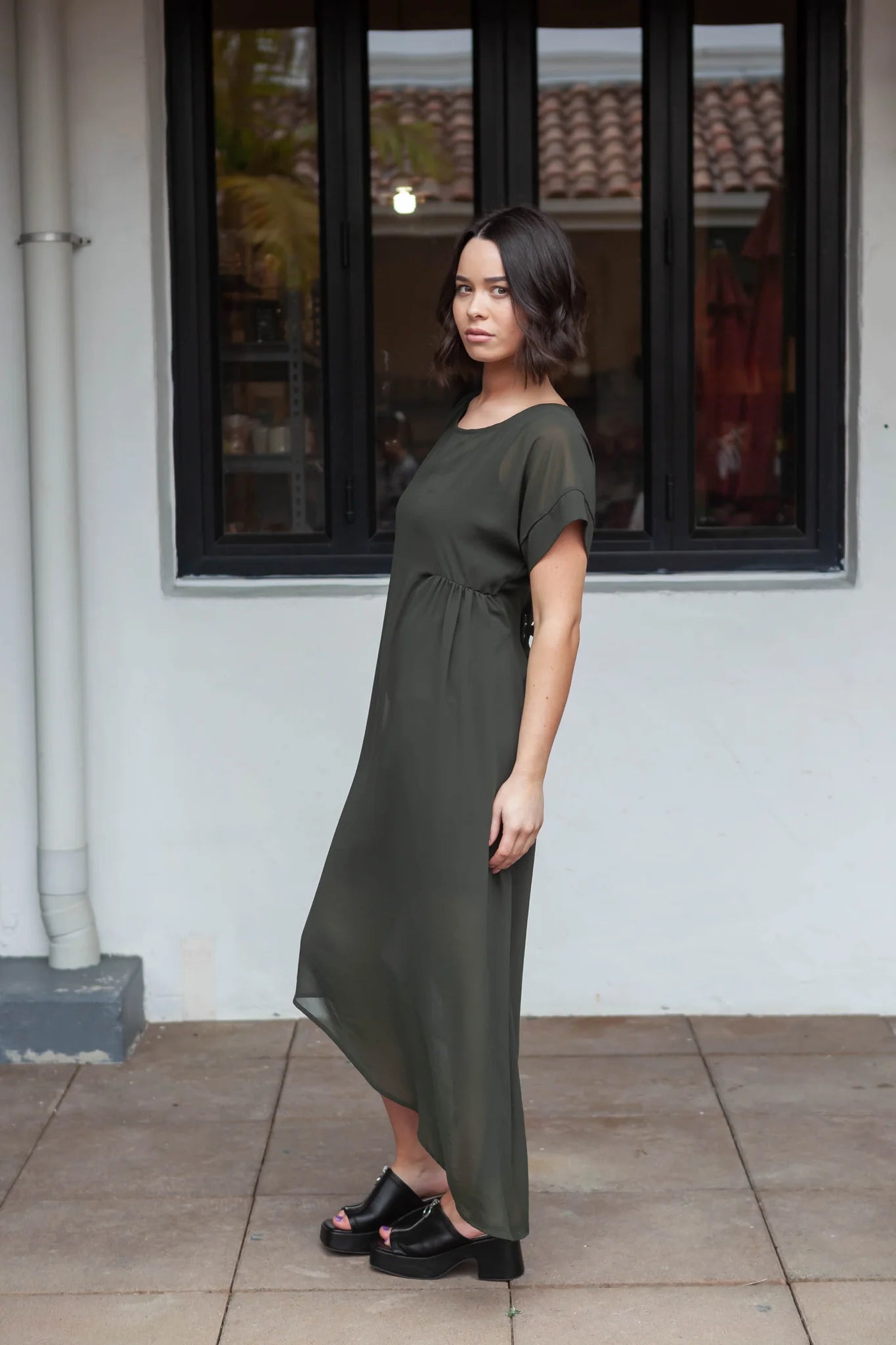 The NES Flow Dress is a multi-seasonal, versatile style that seamlessly transitions from casual to formal occasions. This dress offers a variety of styling options—wear it draped down across the front for a relaxed look, or cinch it up at the side using the adjustable side button and hem loopers for a more structured appearance. The perfect balance of comfort and elegance, this dress can be styled with our Lattice Slip