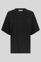 MSCH Kinsey Melea Tee in black by MSCH Copenhagen. Oversized organic cotton T-shirt with a round neckline, dropped shoulders and short sleeves for a relaxed boxy fit. Soft everyday staple in 100% organic cotton.