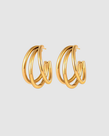 Isla Hoops by Castel & Co are gold-plated stainless steel hoop earrings featuring interlocking bands that create depth and movement with every turn. Their layered silhouette adds a sculptural edge to the classic hoop, striking a balance between statement and sophistication. Designed to stand out while remaining versatile for everyday wear. Measuring 2.5 x 1.6 cm with a secure stud closure. Lightweight (8g), waterproof, and hypoallergenic.