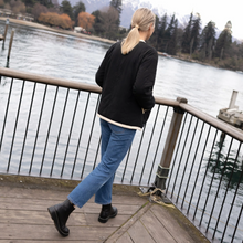 Juniper by Moke women’s reversible winter jacket with two distinct looks. One side features a clean silhouette with contrast piping for a refined everyday finish, while the reverse reveals plush faux shearling with soft pile texture for added warmth and a cosy statement feel. Designed for effortless layering, this thicker winter essential offers a relaxed yet polished fit, versatile styling, and is thoughtfully designed in New Zealand.