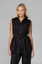 The BLAK Kent Vest offers quality cotton denim with traditional white topstitching in a comfortable relaxed fit. Features include easy-to-use dome closures, a flattering collar, and practical front pockets for your essentials. The included tie belt helps create your ideal silhouette, while the thoughtfully designed back with inverted pleat ensures both comfort and movement. 