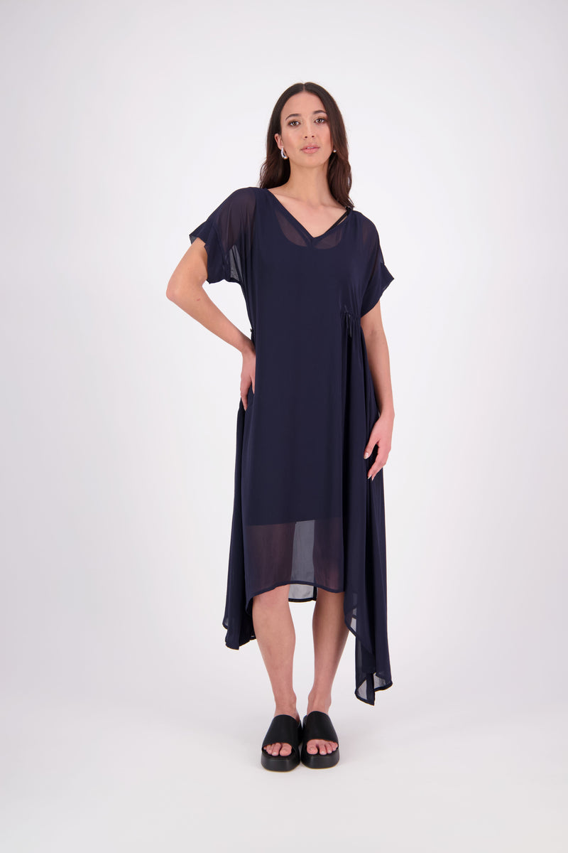The NES Kira Dress blends the best of two favourites – the elegance of the Dreamliner and the versatility of the Flow Dress. With a relaxed drape and subtle tailoring, it features a flattering V-neckline, rouching under the bust on one side, cap sleeves, and adjustable button loop detailing for styling versatility (one dress - wear it 3 ways).