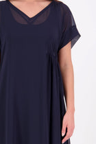 The NES Kira Dress blends the best of two favourites – the elegance of the Dreamliner and the versatility of the Flow Dress. With a relaxed drape and subtle tailoring, it features a flattering V-neckline, rouching under the bust on one side, cap sleeves, and adjustable button loop detailing for styling versatility (one dress - wear it 3 ways).