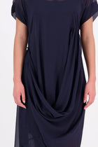 The NES Kira Dress blends the best of two favourites – the elegance of the Dreamliner and the versatility of the Flow Dress. With a relaxed drape and subtle tailoring, it features a flattering V-neckline, rouching under the bust on one side, cap sleeves, and adjustable button loop detailing for styling versatility (one dress - wear it 3 ways).