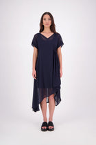 The NES Kira Dress blends the best of two favourites – the elegance of the Dreamliner and the versatility of the Flow Dress. With a relaxed drape and subtle tailoring, it features a flattering V-neckline, rouching under the bust on one side, cap sleeves, and adjustable button loop detailing for styling versatility (one dress - wear it 3 ways).