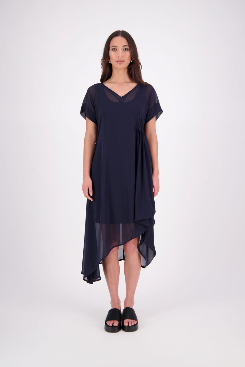 The NES Kira Dress blends the best of two favourites – the elegance of the Dreamliner and the versatility of the Flow Dress. With a relaxed drape and subtle tailoring, it features a flattering V-neckline, rouching under the bust on one side, cap sleeves, and adjustable button loop detailing for styling versatility (one dress - wear it 3 ways).