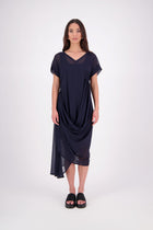The NES Kira Dress blends the best of two favourites – the elegance of the Dreamliner and the versatility of the Flow Dress. With a relaxed drape and subtle tailoring, it features a flattering V-neckline, rouching under the bust on one side, cap sleeves, and adjustable button loop detailing for styling versatility (one dress - wear it 3 ways).