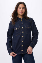 Load image into Gallery viewer, Kireina London Shirt is destined to be a lifelong keepsake and closet staple. This western-inspired denim shirt is perfectly washed in Indigo denim. It has a boyish structured fit, two single-point pockets, single point yokes, and striking gold shank button. Wear this with your favourite jeans for a head-to-toe denim look or unbuttoned over an easy dress.

FEATURES:
- Button-through front
- Single point yokes
- Single point buttoned pockets
- 2-button barrel cuffs

