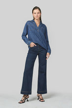 Load image into Gallery viewer, A slight drop shoulder denim shirt crafted in 6 oz Rigid denim. A straight, relaxed silhouette. It boasts a V collar and Straight hem.&nbsp;

Model wears a size 8 and is 176cm tall

Composition: 100% Cotton

BRAND: Dricoper
