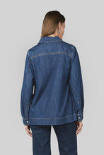 Load image into Gallery viewer, A slight drop shoulder denim shirt crafted in 6 oz Rigid denim. A straight, relaxed silhouette. It boasts a V collar and Straight hem.&nbsp;

Model wears a size 8 and is 176cm tall

Composition: 100% Cotton

BRAND: Dricoper
