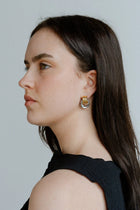 Elegant with a sculptural twist, the Castel & Co Millie Earrings in radiant gold and silver feature an interwoven, knotted form that embodies modern minimalism.

Material: Stainless steel, Gold plating &amp; silver plating
Closure Type: Stud
Earring Size: 2 x 1.3 cm
Waterproof and hypoallergenic
Weight: 6g