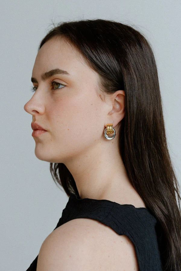 Elegant with a sculptural twist, the Castel & Co Millie Earrings in radiant gold and silver feature an interwoven, knotted form that embodies modern minimalism.

Material: Stainless steel, Gold plating &amp; silver plating
Closure Type: Stud
Earring Size: 2 x 1.3 cm
Waterproof and hypoallergenic
Weight: 6g