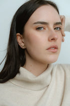 Polished and feminine, the Castel & Co Mini Bow Earrings in X-Small gold bring a bolder expression of the classic bow silhouette. With graceful curves and a radiant finish, they strike the perfect balance between statement and sophistication.

Material: Stainless steel, Gold plating
Closure Type: Stud
Earring Size: 20 mm
Waterproof and hypoallergenic
Weight: 1.5g