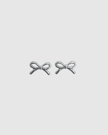 Refined yet playful, the Castel & Co Mini Bow Earrings in medium silver give the classic bow a modern edge. Their polished finish and graceful curves create subtle shine, offering a versatile stud that feels both feminine and contemporary.

Material: Stainless steel
Closure Type: Stud
Earring Size: 20 mm
Waterproof and hypoallergenic
Weight: 1.5g
