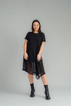 Our NES Aria Dress is a NES favourite and a must-have wardrobe piece! Featuring subtle batwing sleeves, a scoop neck, and front dart and tie detailing, this dress offers a flattering and versatile fit. The front tie can be styled tight or loose for added customization. This mid-length dress is perfect for any occasion, whether dressed up or down. We love styling the chiffon Aria Dress with our NES Lattice Slip underneath for added layering. Wear it as a standalone dress or layer it as a tunic over pants for