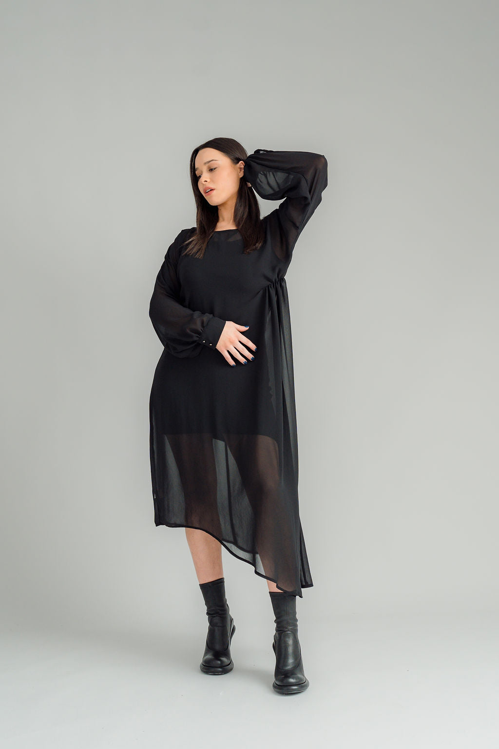 The NES Glide Dress is inspired by our best-selling NES Flow Dress, now with long sleeves for added warmth and versatility. This multi-seasonal dress is perfect for both casual and formal occasions, offering endless styling options. Wear it draped down the front for a relaxed look, or cinch it up at the side with the adjustable side button and hem loopers for a more defined shape. The long sleeves feature elasticated loopers and a metal shank cuff button for added detail. Style it with our Lattice Slip, sne