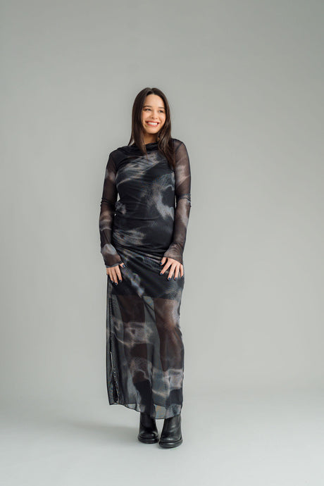 NES Milly Dress is the ultimate body-con layering piece, designed for versatile styling all year round. Wear it on its own with a NES Lattice slip underneath for a sleek, simple look, or layer it over cigarette pants with your favourite knitwear and a winter jacket for added warmth and style. Featuring shirring at the waist, this dress creates flattering ruching around the waist and hip area, enhancing your natural curves.