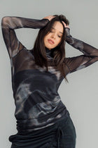 The NES Mesh Funnel Top is a must-have layering piece that adds texture and style to any outfit. Perfect for wearing over a Lattice singlet or layered under a Civita top, this versatile top can be dressed up or down with ease. We’re absolutely obsessed with the Nightscape print, which adds a touch of boldness to your look. Pair it with our new Rielly layer me or combine it with your favourite pants, like the Gin pant, Roxi pant, or Dolly B pant, for a chic and coordinated ensemble. 