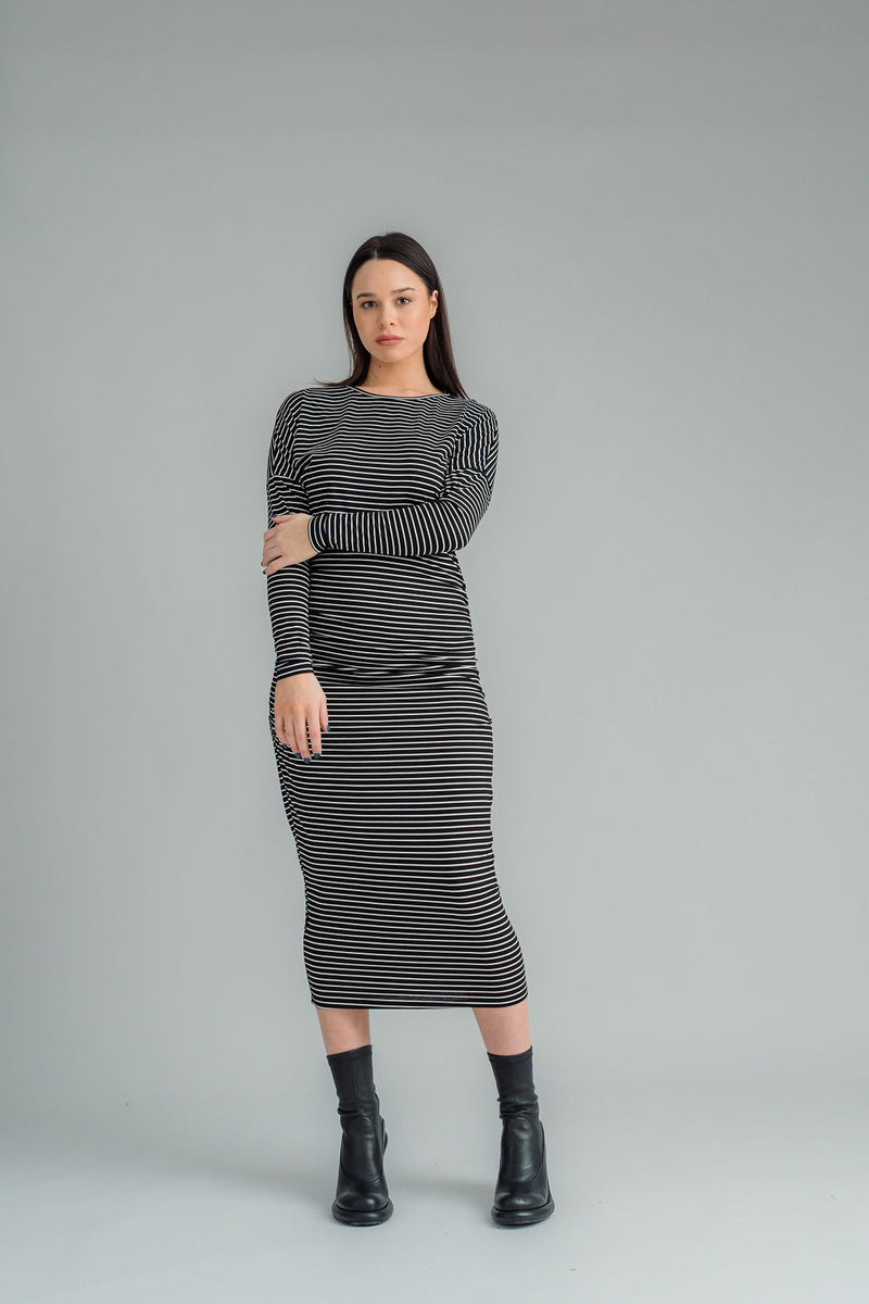NES, Studio 54 Dress. Batwing sleeves that taper into sleek cigarette cuffs, side seam ruching, and a centre back split. Made from a stretchy knit, it offers a flattering fit that moves with you. Composition: viscose spandex