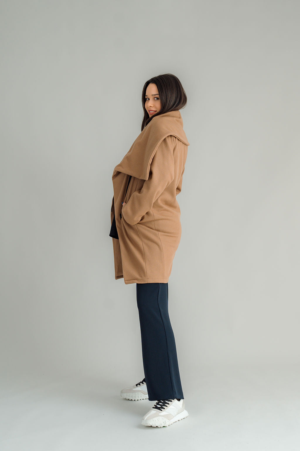 NES Tamara Coat – your ultimate winter companion, designed to elevate both style and comfort. Crafted from a luxurious wool-cashmere blend, this mid-thigh length coat offers the perfect balance of warmth and sophistication. The distinctive angled, exposed contrast black zip adds a modern edge, while the shawl collar gives you versatile styling options. Wear it up and secured with a snap dome for added warmth, or leave it open for a relaxed, draped look across your shoulders
