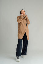 NES Tamara Coat – your ultimate winter companion, designed to elevate both style and comfort. Crafted from a luxurious wool-cashmere blend, this mid-thigh length coat offers the perfect balance of warmth and sophistication. The distinctive angled, exposed contrast black zip adds a modern edge, while the shawl collar gives you versatile styling options. Wear it up and secured with a snap dome for added warmth, or leave it open for a relaxed, draped look across your shoulders