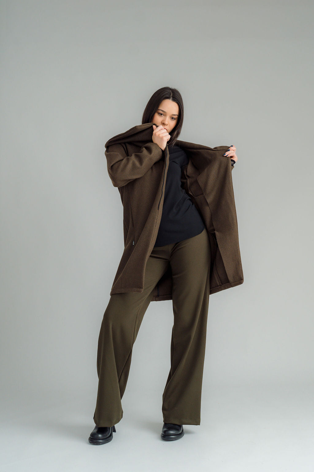 NES Tamara Coat – your ultimate winter companion, designed to elevate both style and comfort. Crafted from a luxurious wool-cashmere blend, this mid-thigh length coat offers the perfect balance of warmth and sophistication. The distinctive angled, exposed contrast black zip adds a modern edge, while the shawl collar gives you versatile styling options. Wear it up and secured with a snap dome for added warmth, or leave it open for a relaxed, draped look across your shoulders