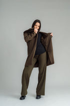NES Tamara Coat – your ultimate winter companion, designed to elevate both style and comfort. Crafted from a luxurious wool-cashmere blend, this mid-thigh length coat offers the perfect balance of warmth and sophistication. The distinctive angled, exposed contrast black zip adds a modern edge, while the shawl collar gives you versatile styling options. Wear it up and secured with a snap dome for added warmth, or leave it open for a relaxed, draped look across your shoulders