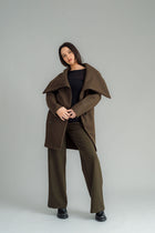 NES Tamara Coat – your ultimate winter companion, designed to elevate both style and comfort. Crafted from a luxurious wool-cashmere blend, this mid-thigh length coat offers the perfect balance of warmth and sophistication. The distinctive angled, exposed contrast black zip adds a modern edge, while the shawl collar gives you versatile styling options. Wear it up and secured with a snap dome for added warmth, or leave it open for a relaxed, draped look across your shoulders