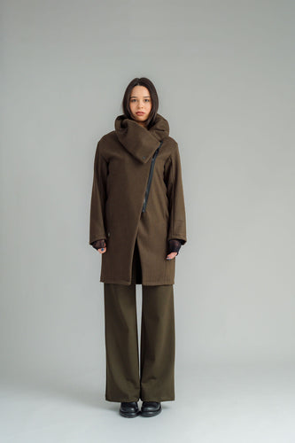 NES Tamara Coat – your ultimate winter companion, designed to elevate both style and comfort. Crafted from a luxurious wool-cashmere blend, this mid-thigh length coat offers the perfect balance of warmth and sophistication. The distinctive angled, exposed contrast black zip adds a modern edge, while the shawl collar gives you versatile styling options. Wear it up and secured with a snap dome for added warmth, or leave it open for a relaxed, draped look across your shoulders