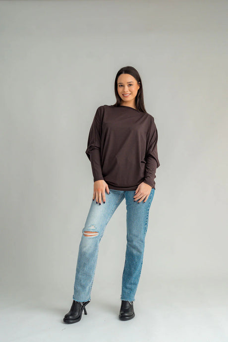 Our NES June Tunic is a jumper/tunic with a slight asymmetrical hemline that features a self band allowing you to gather the top up or wear pulled down into a tunic. It has bat wing sleeves and a cigarette sleeve cuff helping to add some slimness to this style. Dress this style up or down. 