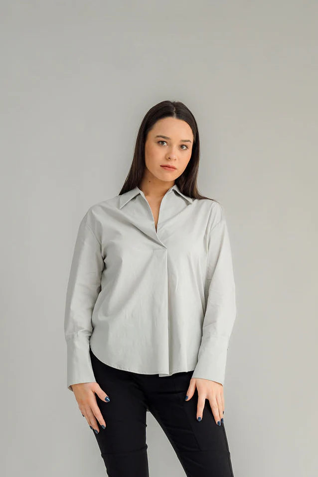 The NES Billie Shirt  long sleeves and a stretchy shirt fabric. Small metal shank buttons on the cuff and elastic loopers. cotton rayon stretch