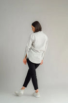The NES Billie Shirt  long sleeves and a stretchy shirt fabric. Small metal shank buttons on the cuff and elastic loopers. cotton rayon stretch