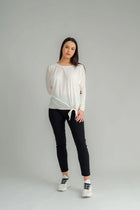 The NES Merino Leisure Tie Top is a stylish and versatile piece, perfect for pairing with your favourite denim, Dolly B pants, Drilled Gin pants, or the Ribs skirt. This top features a self-tie at the side that can be adjusted to your liking—tied tight for a more structured look or looped loose for a relaxed feel. With its batwing design and cigarette sleeves, it offers a flattering silhouette that adds slimness to your lower arms while providing maximum comfort. 100% merino