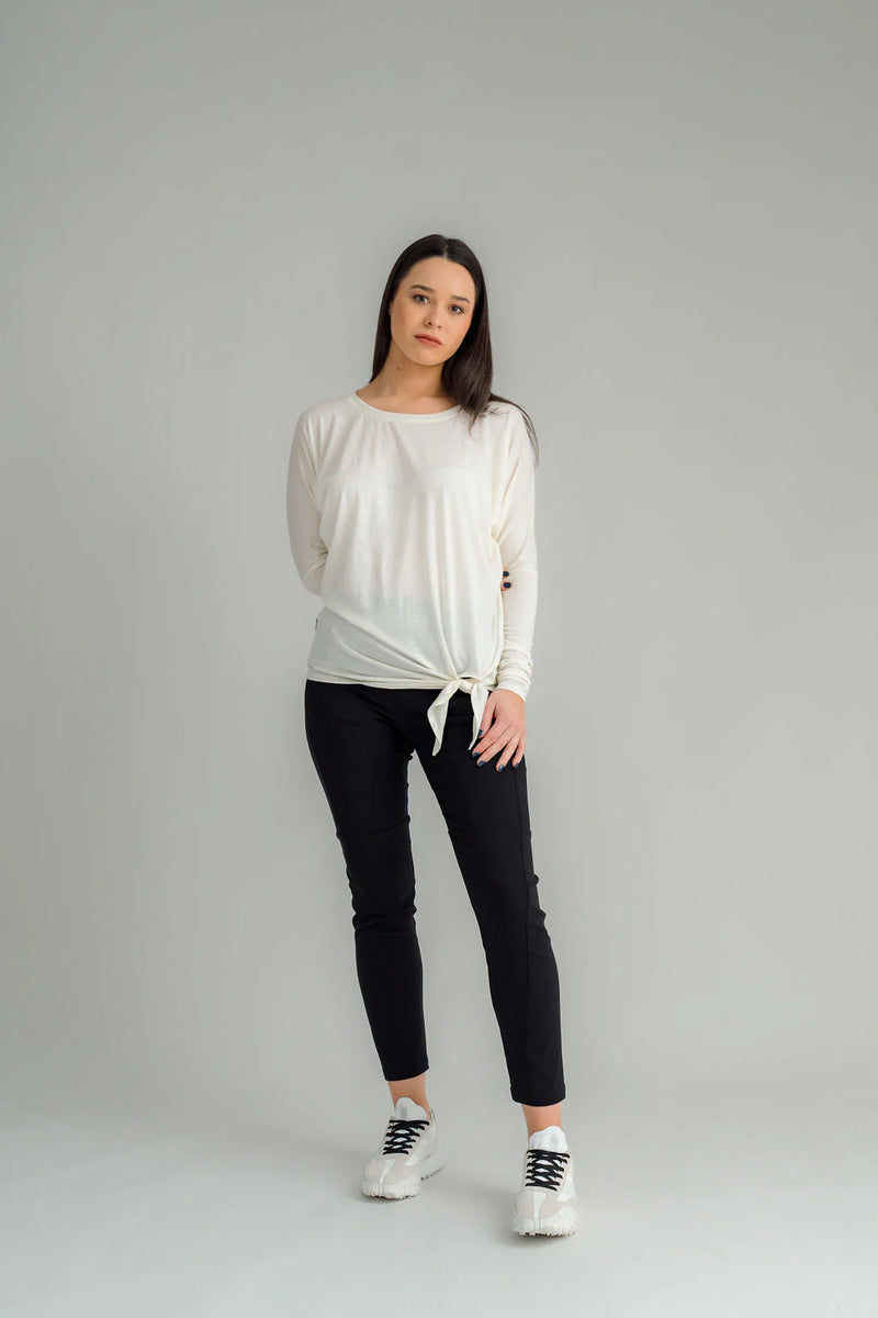 The NES Merino Leisure Tie Top is a stylish and versatile piece, perfect for pairing with your favourite denim, Dolly B pants, Drilled Gin pants, or the Ribs skirt. This top features a self-tie at the side that can be adjusted to your liking—tied tight for a more structured look or looped loose for a relaxed feel. With its batwing design and cigarette sleeves, it offers a flattering silhouette that adds slimness to your lower arms while providing maximum comfort. 100% merino