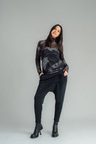 The NES Mesh Funnel Top is a must-have layering piece that adds texture and style to any outfit. Perfect for wearing over a Lattice singlet or layered under a Civita top, this versatile top can be dressed up or down with ease. We’re absolutely obsessed with the Nightscape print, which adds a touch of boldness to your look. Pair it with our new Rielly layer me or combine it with your favourite pants, like the Gin pant, Roxi pant, or Dolly B pant, for a chic and coordinated ensemble. 