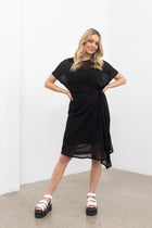 Our NES Aria Dress is a NES favourite and a must-have wardrobe piece! Featuring subtle batwing sleeves, a scoop neck, and front dart and tie detailing, this dress offers a flattering and versatile fit. The front tie can be styled tight or loose for added customization. This mid-length dress is perfect for any occasion, whether dressed up or down. We love styling the chiffon Aria Dress with our NES Lattice Slip underneath for added layering. Wear it as a standalone dress or layer it as a tunic over pants for
