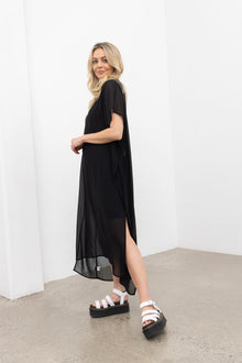 Sheer elegance in every sense — the NES Civita Dress is your statement piece for effortless sophistication. Crafted in lightweight, anti-crease poly chiffon, it’s perfect for travel and multi-seasonal wear. Featuring an open-sided design, this oversized silhouette can be worn loose and floaty or knotted to the side for shape. Easily dressed up or down, it’s a versatile piece that moves with you.