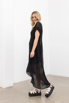 The NES Flow Dress is a multi-seasonal, versatile style that seamlessly transitions from casual to formal occasions. This dress offers a variety of styling options—wear it draped down across the front for a relaxed look, or cinch it up at the side using the adjustable side button and hem loopers for a more structured appearance. The perfect balance of comfort and elegance, this dress can be styled with our Lattice Slip