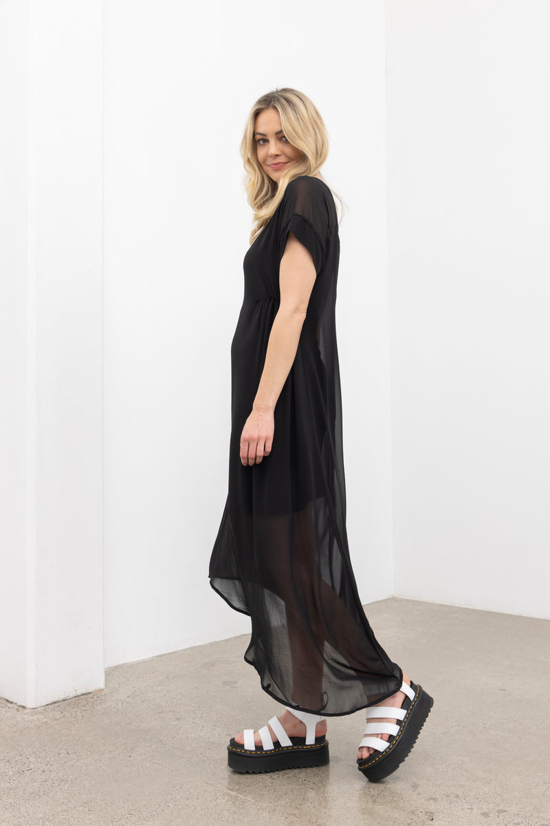 The NES Flow Dress is a multi-seasonal, versatile style that seamlessly transitions from casual to formal occasions. This dress offers a variety of styling options—wear it draped down across the front for a relaxed look, or cinch it up at the side using the adjustable side button and hem loopers for a more structured appearance. The perfect balance of comfort and elegance, this dress can be styled with our Lattice Slip