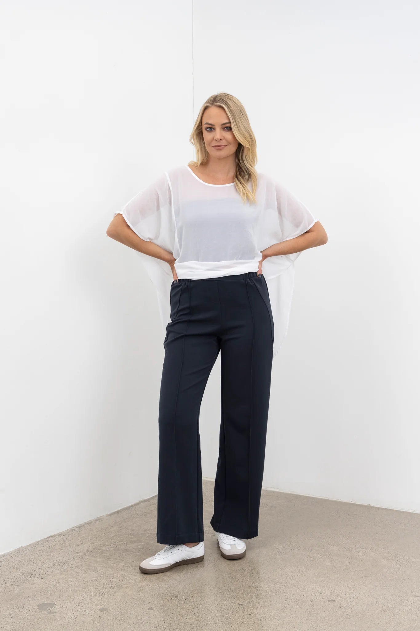 The NES Ginnie Pant is a stylish update to our top-selling Gin Pants, now featuring a pin stitch pleat down the front legs for an elongated, flattering silhouette. With a classic cut that’s easy to dress up or down, these pants are perfect for both work and everyday wear. The centre leg pin stitch detailing adds a touch of sophistication, while the flat front and covered elasticated back provide a comfortable, secure fit. The flattering angled panel at the front enhances the shape, and the full-length strai