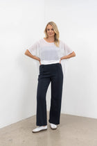 The NES Ginnie Pant is a stylish update to our top-selling Gin Pants, now featuring a pin stitch pleat down the front legs for an elongated, flattering silhouette. With a classic cut that’s easy to dress up or down, these pants are perfect for both work and everyday wear. The centre leg pin stitch detailing adds a touch of sophistication, while the flat front and covered elasticated back provide a comfortable, secure fit. The flattering angled panel at the front enhances the shape, and the full-length strai