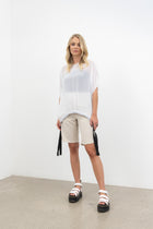 NES Gin linen short. Natural. A classic chic cut that is so easily dressed up or down.
Perfect for work, beach and effortless everyday wear.
Features angled pockets.
Flat front & covered elasticated back.
Leg length finish just on the knee.