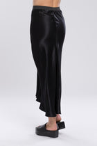 The NES Muse Skirt is the ultimate statement piece—elegant, fluid, and designed to stand out. With a flattering bias cut and a soft concave front that flows into a dropped back hem, this skirt moves beautifully with the body. The wide elasticated waistband offers all-day comfort, while the luxe drape of 100% viscose adds a sophisticated sheen. Multi-seasonal and effortlessly versatile, the Muse Skirt is perfect for pairing with everything from a casual tee to a tailored blazer.