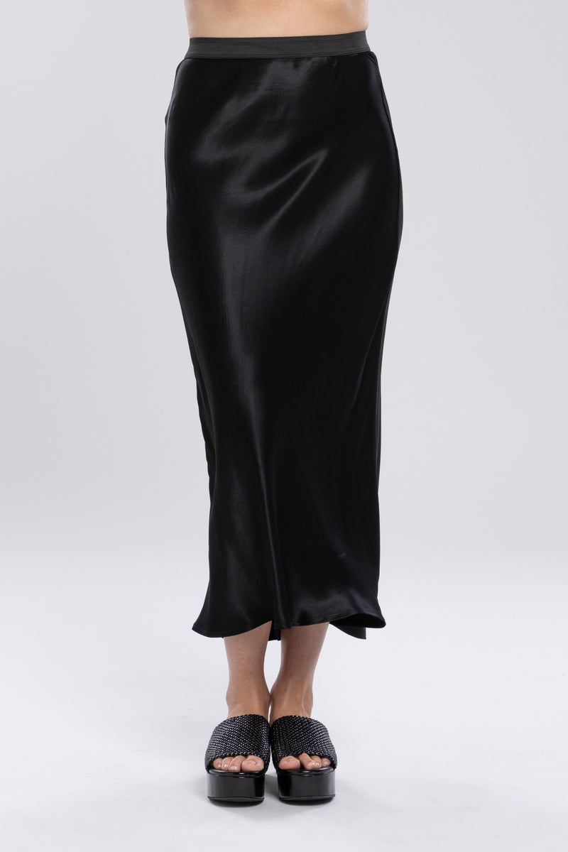 The NES Muse Skirt is the ultimate statement piece—elegant, fluid, and designed to stand out. With a flattering bias cut and a soft concave front that flows into a dropped back hem, this skirt moves beautifully with the body. The wide elasticated waistband offers all-day comfort, while the luxe drape of 100% viscose adds a sophisticated sheen. Multi-seasonal and effortlessly versatile, the Muse Skirt is perfect for pairing with everything from a casual tee to a tailored blazer.