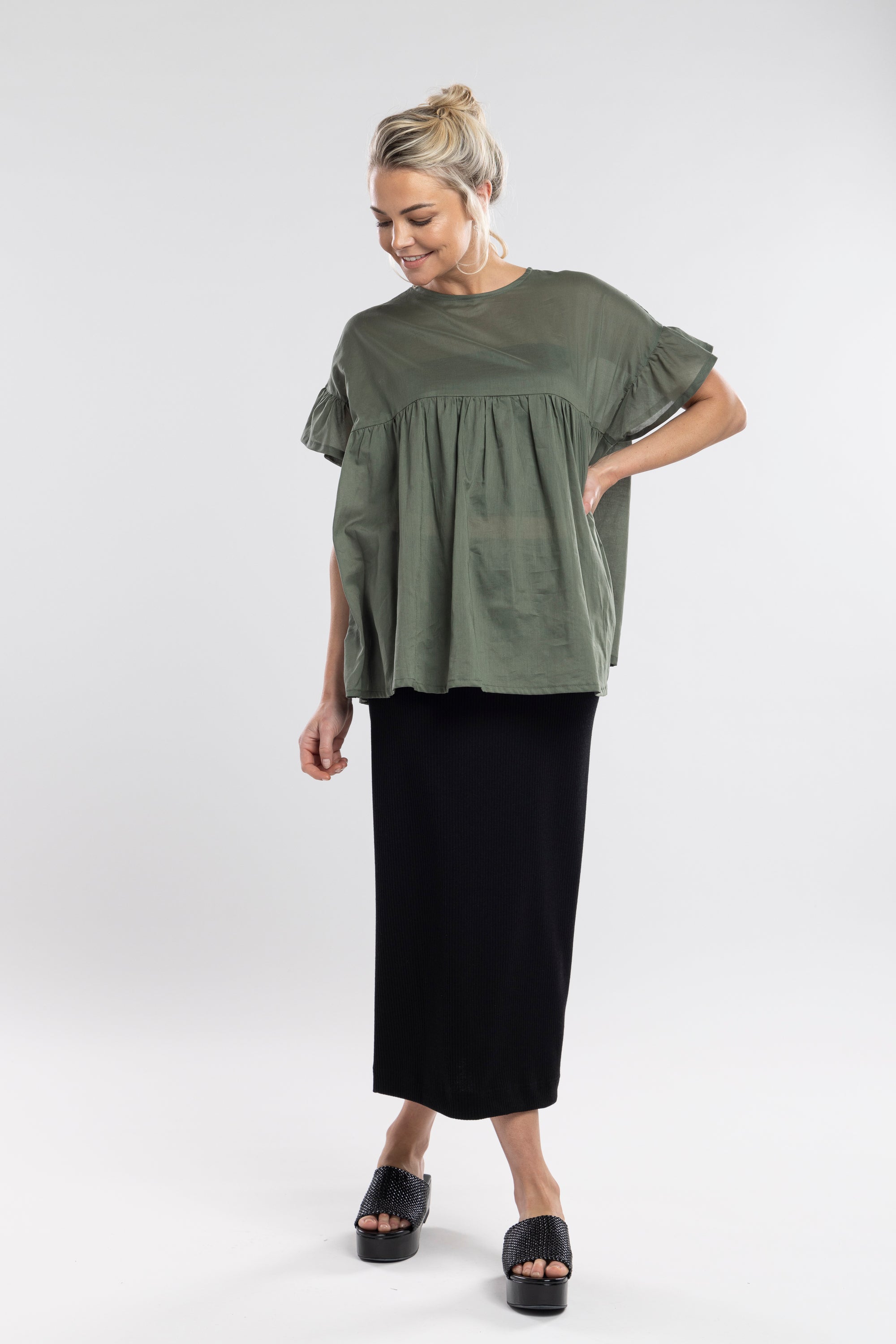 The NES Ribs Skirt blends effortless style with all-day comfort, making it a versatile essential for any wardrobe. Designed to skim the body without clinging, this skirt features a soft elasticated waistband, a centre back seam, and a subtle back split for ease of movement. Crafted from a ribbed polyester/spandex blend, it offers just the right amount of stretch and structure—ideal for everyday wear or layered with elevated pieces for a more polished look. A sleek, pull-on style that works across seasons an