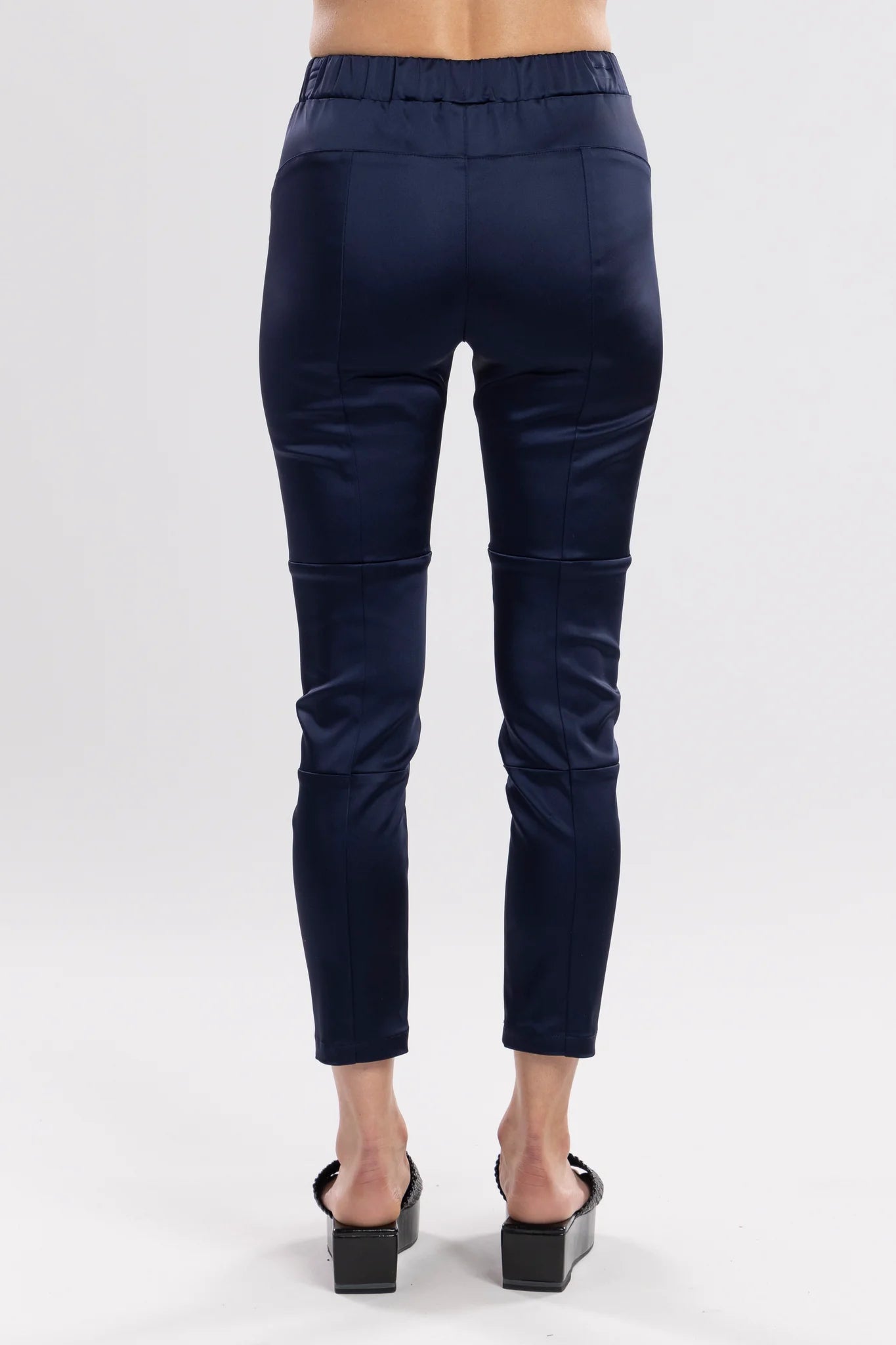 The Satin Section Pant is your go-to slightly more dressy NES essential, offering effortless style and unmatched comfort. With fabulous spliced detailing, this pant combines a sleek flat front with an elasticated back for the perfect fit. Side pockets provide practicality, while the 7/8 length and satin finish add an elevated touch to your look. Whether you're dressing up for a night out, office wear, or a special occasion, these versatile pants can easily be styled for any event. 