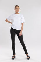 The NES Skinnie Minnies Pant is your go-to for sleek, everyday style with a modern edge. Crafted from the same super stretchy twill fabric you love, these pants are all about a flattering fit and effortless comfort. Featuring a cigarette-style slim leg, flat waistband, and a concealed side seam zip, the Skinnie Minnies offer a streamlined silhouette that's both polished and wearable.